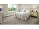 Bright bedroom with soft carpet, a large window, and patterned bedding atop a comfortable bed at 549 Freedom Trail Dr, Willow Springs, NC 27592