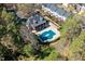 Aerial view of a neighborhood pool and clubhouse, surrounded by lush trees and manicured landscaping at 5569 Sea Daisy Dr, Raleigh, NC 27606