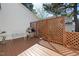 A wooden deck with an outdoor grill, white bench, and privacy lattice is perfect for relaxing and entertaining at 5569 Sea Daisy Dr, Raleigh, NC 27606