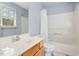 Bathroom boasts white vanity, single sink and shower-tub combo and light blue walls at 5569 Sea Daisy Dr, Raleigh, NC 27606