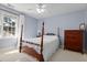 Bedroom has light-blue walls and standard height ceiling, a window and wood furnishings at 5569 Sea Daisy Dr, Raleigh, NC 27606