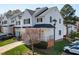 View of well-maintained townhome featuring green lawn, attached garages, and manicured landscaping at 5569 Sea Daisy Dr, Raleigh, NC 27606