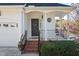 Welcoming front porch with brick steps, decorative wreath on door, and well-maintained landscaping at 5569 Sea Daisy Dr, Raleigh, NC 27606