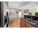 View of kitchen leading to dining area, featuring stainless steel appliances and tile backsplash at 5569 Sea Daisy Dr, Raleigh, NC 27606