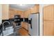 Functional kitchen featuring stainless steel appliances, granite countertops, and wood cabinets at 5569 Sea Daisy Dr, Raleigh, NC 27606