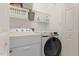 Laundry room features modern appliances, overhead storage and white walls at 5569 Sea Daisy Dr, Raleigh, NC 27606