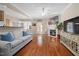 Cozy living room with hardwood floors, fireplace, and comfortable seating arrangement near a dining area at 5569 Sea Daisy Dr, Raleigh, NC 27606