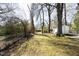 Large backyard with a storage shed and mature trees at 608 Cecil St, Durham, NC 27707