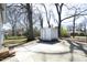 Spacious backyard with a concrete patio and a storage shed surrounded by mature trees at 608 Cecil St, Durham, NC 27707