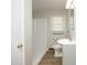 Bathroom showcasing a toilet, shower, sink, wood flooring, and bright lighting at 608 Cecil St, Durham, NC 27707