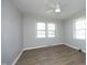 Bedroom featuring two windows for natural light and wood flooring at 608 Cecil St, Durham, NC 27707