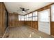 Enclosed porch with lots of natural light and a ceiling fan at 608 Cecil St, Durham, NC 27707