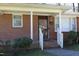 Welcoming brick entryway with white trim and a classic front door, providing a charming first impression at 608 Cecil St, Durham, NC 27707