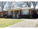 Charming brick home with a well-maintained lawn and a cozy covered porch, perfect for relaxing outdoors at 608 Cecil St, Durham, NC 27707
