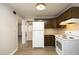 Efficient kitchen with white appliances, wood cabinets, and tiled countertops, ideal for meal preparation at 608 Cecil St, Durham, NC 27707