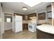 Functional kitchen featuring white appliances, wood cabinetry, and tiled countertops, ready for home cooking at 608 Cecil St, Durham, NC 27707