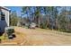 Large backyard with mature trees, playset, and swing, offering space for outdoor activities and relaxation at 6108 Norwood Place Ct, Raleigh, NC 27613