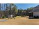 Expansive backyard featuring a custom playhouse and a sunken trampoline, perfect for Gathering fun and outdoor activities at 6108 Norwood Place Ct, Raleigh, NC 27613
