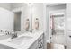 Bright bathroom with double sinks, quartz countertop, framed mirror and stylish fixtures at 6108 Norwood Place Ct, Raleigh, NC 27613