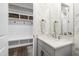 Charming bathroom featuring floral wallpaper, a built-in bench, and shaker-style vanity at 6108 Norwood Place Ct, Raleigh, NC 27613