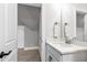 Cozy bathroom featuring a single sink with granite counters and a view into a carpeted bonus room at 6108 Norwood Place Ct, Raleigh, NC 27613