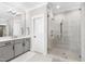 Modern bathroom featuring a glass-enclosed shower, dual shower heads, and a neutral color scheme at 6108 Norwood Place Ct, Raleigh, NC 27613