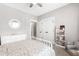Bright bedroom featuring a floral bedspread, comfortable gray chair and a dresser and bookshelf combo at 6108 Norwood Place Ct, Raleigh, NC 27613