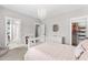 Cozy bedroom showcasing a chandelier, a white dresser, and an open ensuite bathroom and closet at 6108 Norwood Place Ct, Raleigh, NC 27613