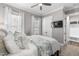 Comfortable bedroom with ceiling fan, ample natural light, and a view into the bathroom at 6108 Norwood Place Ct, Raleigh, NC 27613