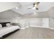 Bonus room bedroom with unique architectural ceilings, neutral colors, carpet, and modern ceiling fan at 6108 Norwood Place Ct, Raleigh, NC 27613
