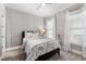 Cozy bedroom with paneled walls, a ceiling fan, and natural light from dual windows at 6108 Norwood Place Ct, Raleigh, NC 27613