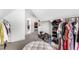 Spacious walk-in closet with built in shelving, clothes racks, and ample space for storage at 6108 Norwood Place Ct, Raleigh, NC 27613