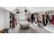 Spacious walk-in closet with custom shelving, natural light, and a comfortable center ottoman at 6108 Norwood Place Ct, Raleigh, NC 27613