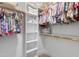Organized closet with hanging clothes, folded towels, and basket storage on the shelving system at 6108 Norwood Place Ct, Raleigh, NC 27613