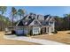 Beautiful two-story home with a three-car garage and manicured lawn at 6108 Norwood Place Ct, Raleigh, NC 27613