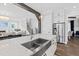 Bright, open kitchen features a stainless steel sink and appliances with an open view to the living room at 6108 Norwood Place Ct, Raleigh, NC 27613