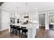 Gourmet kitchen with a large island, stainless steel appliances, and custom white cabinets at 6108 Norwood Place Ct, Raleigh, NC 27613