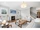 Open concept living room features a fireplace, hardwood floors, plush seating, and lots of natural light at 6108 Norwood Place Ct, Raleigh, NC 27613