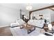 Cozy living room boasts an open floor plan, plush seating, wood beams, and hardwood floors at 6108 Norwood Place Ct, Raleigh, NC 27613