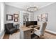 Bright home office with a comfortable chair, large desk, and sophisticated decor, creating an ideal work environment at 6108 Norwood Place Ct, Raleigh, NC 27613