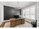 Modern home office featuring a sleek desk, statement wall, and plenty of natural light for a productive workspace at 6108 Norwood Place Ct, Raleigh, NC 27613