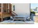 Outdoor patio area under deck with wooden table and chairs and a built-in outdoor grill at 6108 Norwood Place Ct, Raleigh, NC 27613