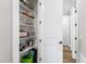 Walk-in pantry features bright white shelving stocked with plates, bowls, pots, and other items at 6108 Norwood Place Ct, Raleigh, NC 27613