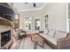 Inviting screened-in porch with stone fireplace, comfortable seating, and natural light, perfect for relaxation at 6108 Norwood Place Ct, Raleigh, NC 27613