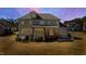 Exterior view of home, showing large backyard, patio, and screened in porch at 6108 Norwood Place Ct, Raleigh, NC 27613