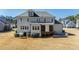 Rear view of home showcasing yard, patio area, screened-in porch and landscaped garden at 6108 Norwood Place Ct, Raleigh, NC 27613