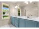 Bathroom with dual sinks, shaker cabinets, a large mirror, and natural light at 65 Stream View Way, Spring Hope, NC 27882