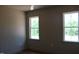 Bedroom featuring two bright windows and hardwood flooring at 65 Stream View Way, Spring Hope, NC 27882