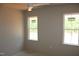 Bright bedroom featuring natural light from two windows and a modern ceiling fan at 65 Stream View Way, Spring Hope, NC 27882