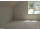 Well lit bedroom featuring ample sunlight from the large window at 65 Stream View Way, Spring Hope, NC 27882